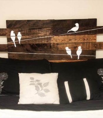 recycled pallet headboard with painted bird wall art