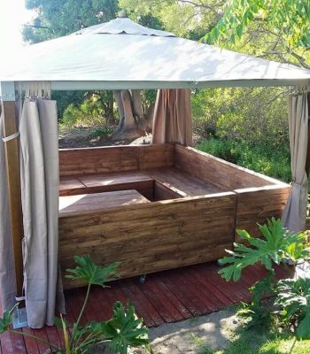 Recycled pallet u shape couch under gazebo