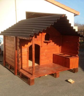 wooden pallet dog house with chevron shingled roof